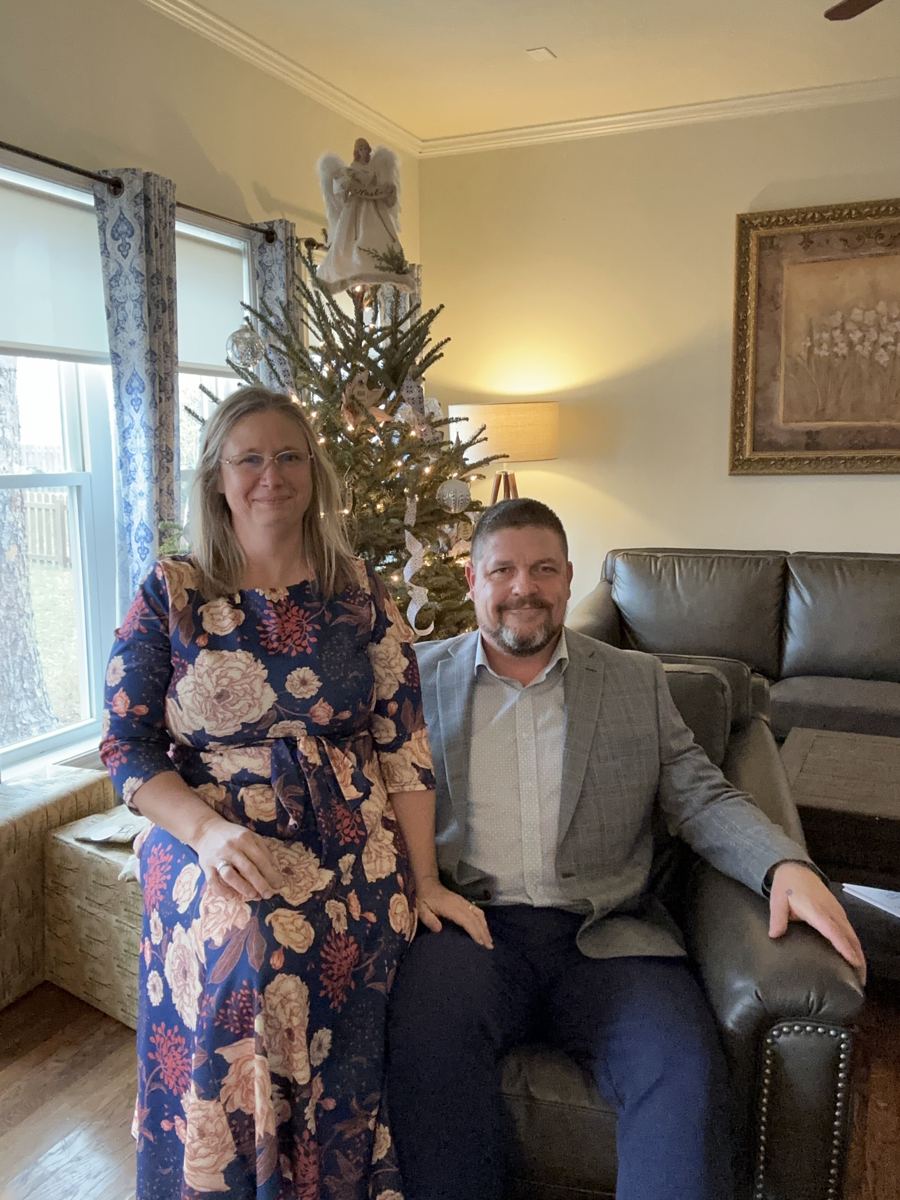 Steve and Sheri Baumgartner at home by the Christmas tree